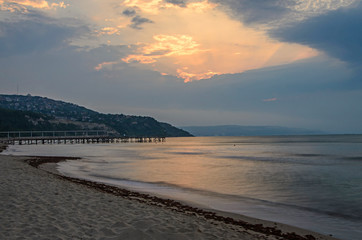 The Black Sea shore from Albena, Bulgaria with golden sands, sunset, blue mystic water, seaside bridge near Kaliakra hotel