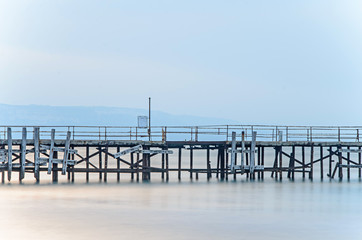 Old bridge over the mystical blue sea water, The Black Sea shore coastline seaside