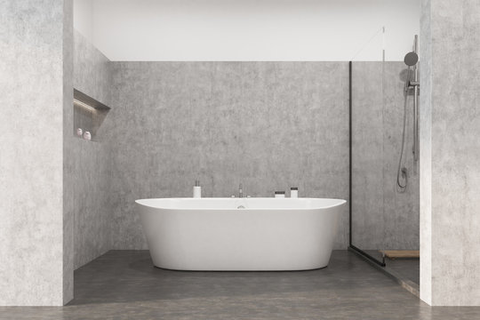 Gray bathroom with a white tub