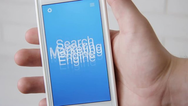 Search engine marketing concept application on the smartphone. Man uses mobile app.