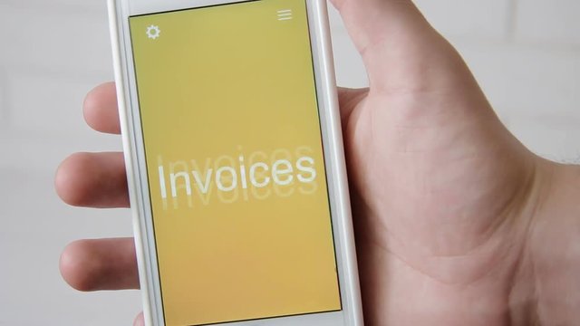 Invoices concept application on the smartphone. Man uses mobile app.