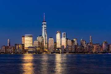 New York City Financial District skyscrapers and Hudson River at dusk. Panoramic view of Lower Manhattan