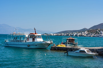 Naklejka premium Boats in a blue sea, Elounda coast of Crete island in Greece