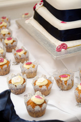 Beautiful inviting Sponge and cream cup cakes with a shallow depth of field, photographed on a table.