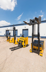 london, england, 10/05/ 2016 Big vivid yellow modern pedestrian forklift machines. Pedestrian...