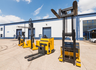 london, england, 10/05/ 2016 Big vivid yellow modern pedestrian forklift machines. Pedestrian counterbalanced stackers and Heavy duty industrial powered pedestrian stackers. © dannyburn