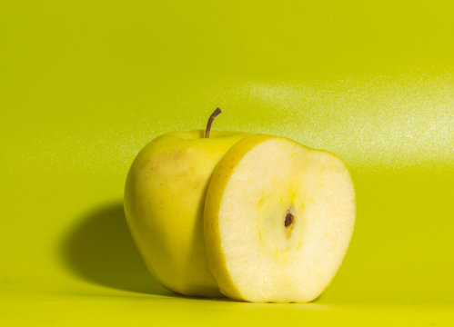 on a green background yellow Apple, close up.