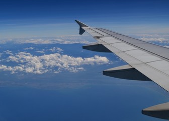 Fototapeta na wymiar Wing of airplane in flight