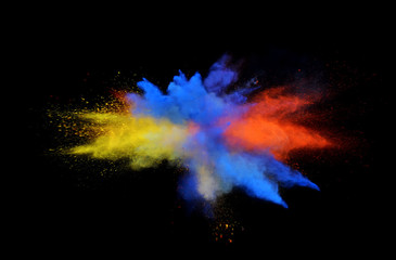 Multi color explosions of powder paint create abstract forms in front of a black background giving off fantastic colors formations.