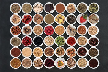 Aphrodisiac food sampler of foods to promote sexual health in china bowls on slate background.