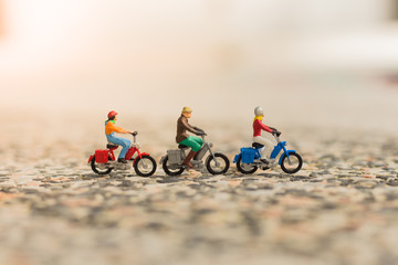 Miniature people, travelers with bicycle on the road, cyling to destination