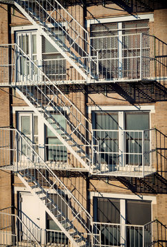 Fototapeta  Exterior of a building with old fire escape in  New York City