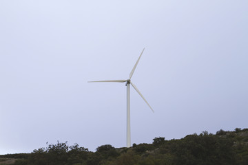 Fototapeta na wymiar wind turbines generating clean renewable eolic energy in a stormy day