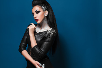 Girl with creative make-up on a blue background