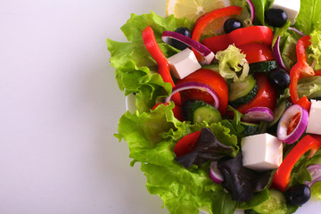 salad from fresh vegetables in a plate on a table, selective focus