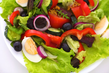 salad from fresh vegetables in a plate on a table, selective focus