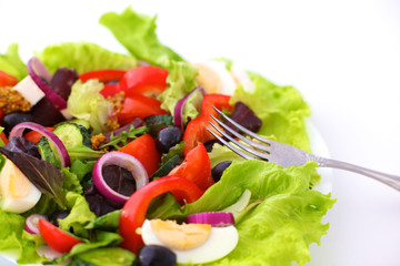 salad from fresh vegetables in a plate on a table, selective focus