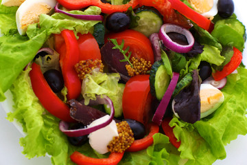 salad from fresh vegetables in a plate on a table, selective focus