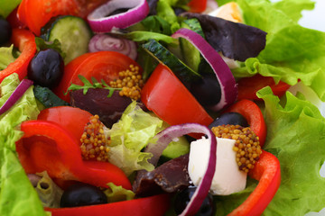 salad from fresh vegetables in a plate on a table, selective focus
