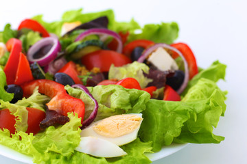 salad from fresh vegetables in a plate on a table, selective focus