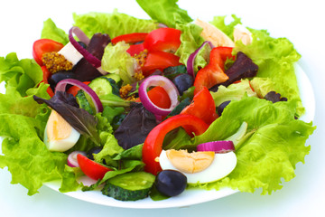 salad from fresh vegetables in a plate on a table, selective focus