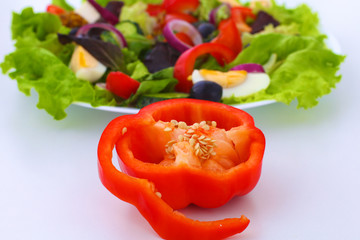 salad from fresh vegetables in a plate on a table, selective focus