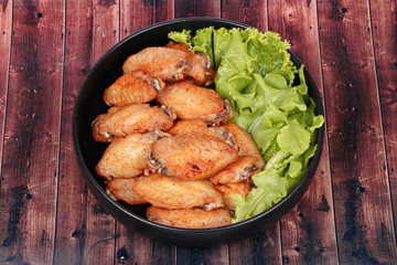 Deep fried chicken wings topped green oak.