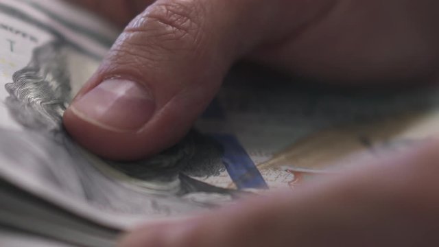 slow motion macro man hands counting dollars