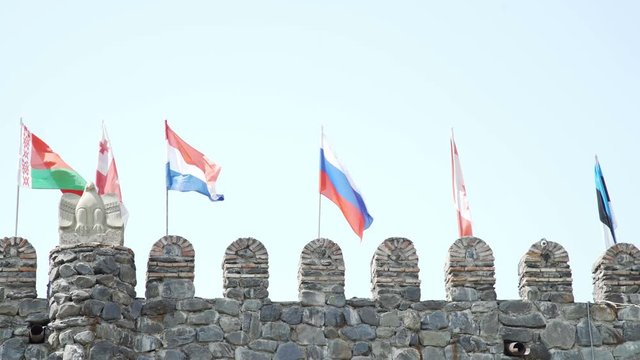 Russian Canadian French Belorussian Georgian Estonian Flags on fortress wall