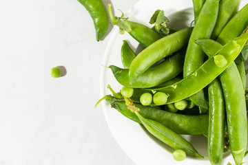 Green peas in a white plate.