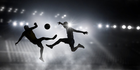 Fototapeta na wymiar Silhouettes of two soccer players . Mixed media