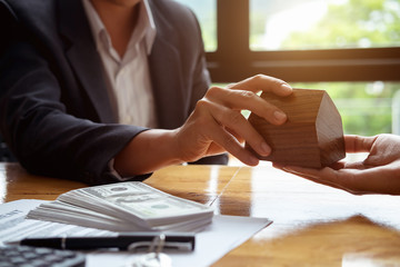 real estate agent holding house to his client after signing contract,concept for real estate,...