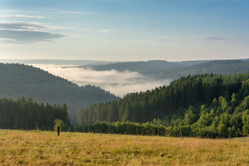 Belgian countryside - Ardennes. View over the Semois valley covered by clouds in the Belgian Ardennes in the morning.