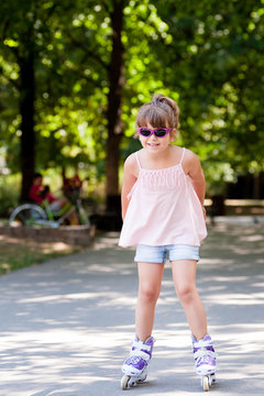 Little girl with sunglasses on in-line skates