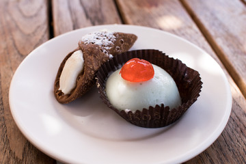 Sicilian cannolo and cassata. Small portion on a white plate. Italian sweets