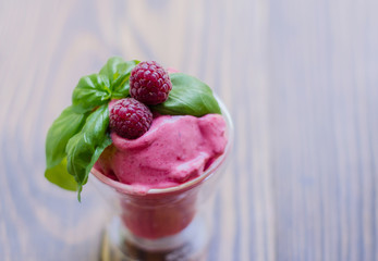Raspberry Ice Cream, summer sundae with fresh fruits on rustic background.