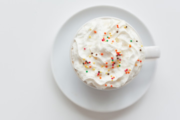 Appetizing latte with whipped cream and sprinkles