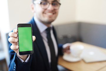 Modern businessman showing touchscreen of gadget