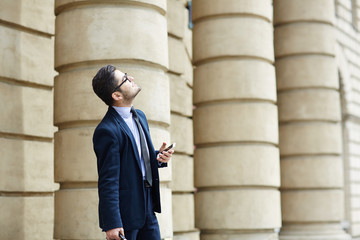 Mobile businessman enjoying leisure in urban environment