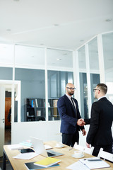 Director of enterprise greeting new employee in office