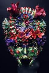Mannequin in mask with with flowers