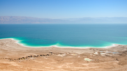 Fototapeta na wymiar Dead Sea lake with salt water and curative mud shores beaches