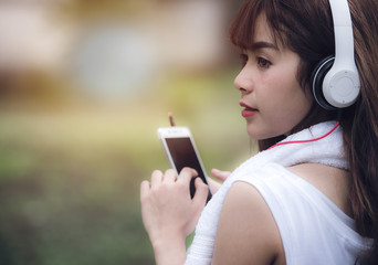 Young beautiful woman listen to music after jogging during sunlight © NAMPIX