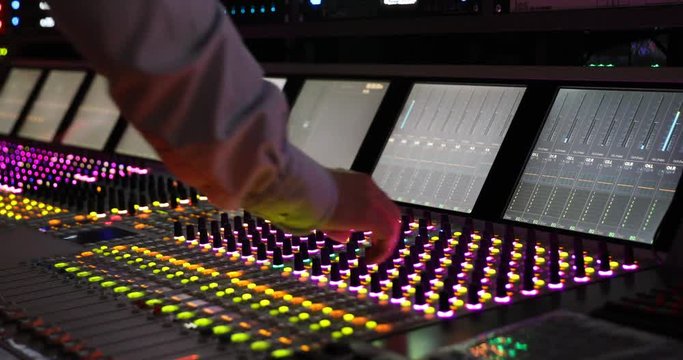 Hands of Audio engineer working. Professional audio mixer, sound engineer, producer control engineer, audio mixing console