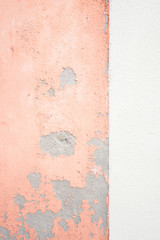 Close up texture of shabby peach and white wall background.