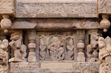 Ancient carvings with dancing women in Indian style, on ceremonial cart of Hindu temple. Old structure in India