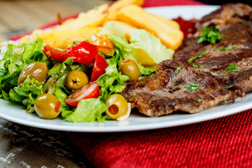 juicy steak beef meat with tomato and french fries