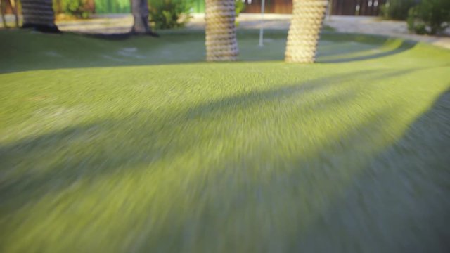 Camera travel over mini golf course stopping at hole 4K