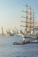 Large sailing ship in city port at berth