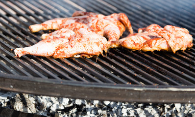 Pickled chicken fried on a large barbecue